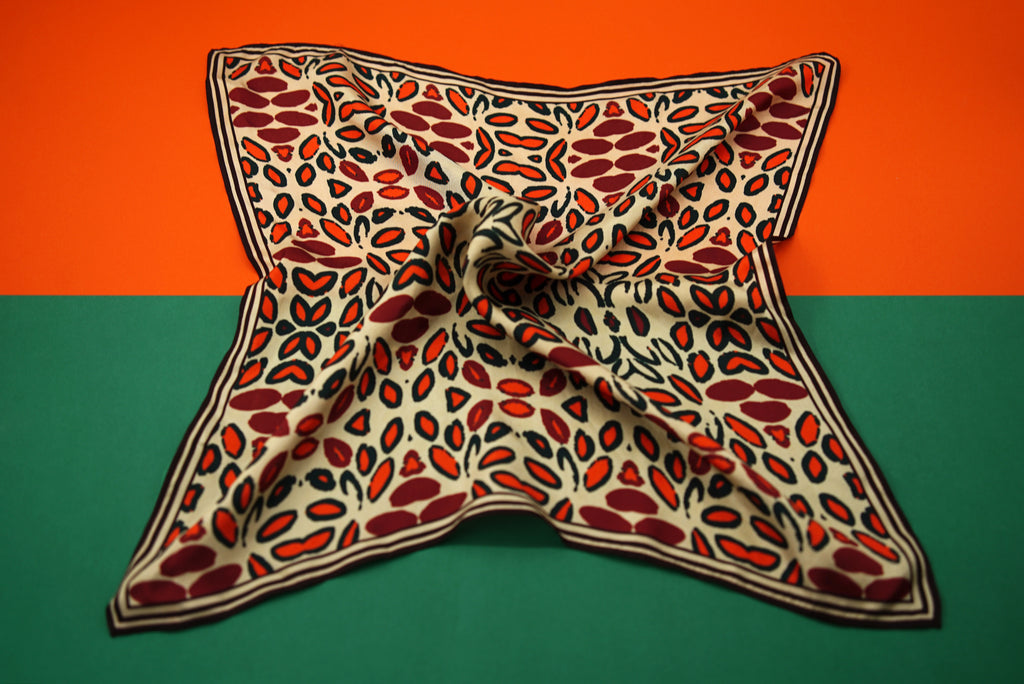 sporty stripe bordered feminine floral design scarf in oranges and reds