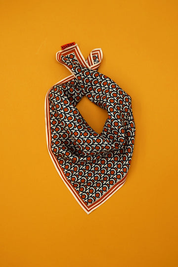 scarf in iconic dalya a logo in burnt oranges with striped edges