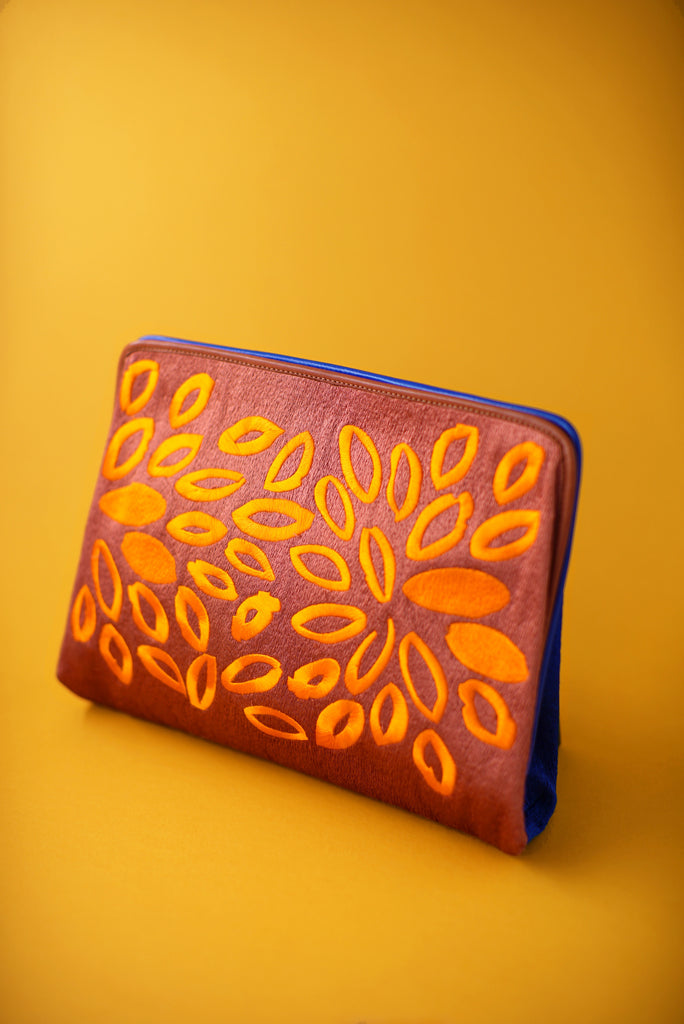 rust suede and electric blue clutch with bright orange flower embroidery